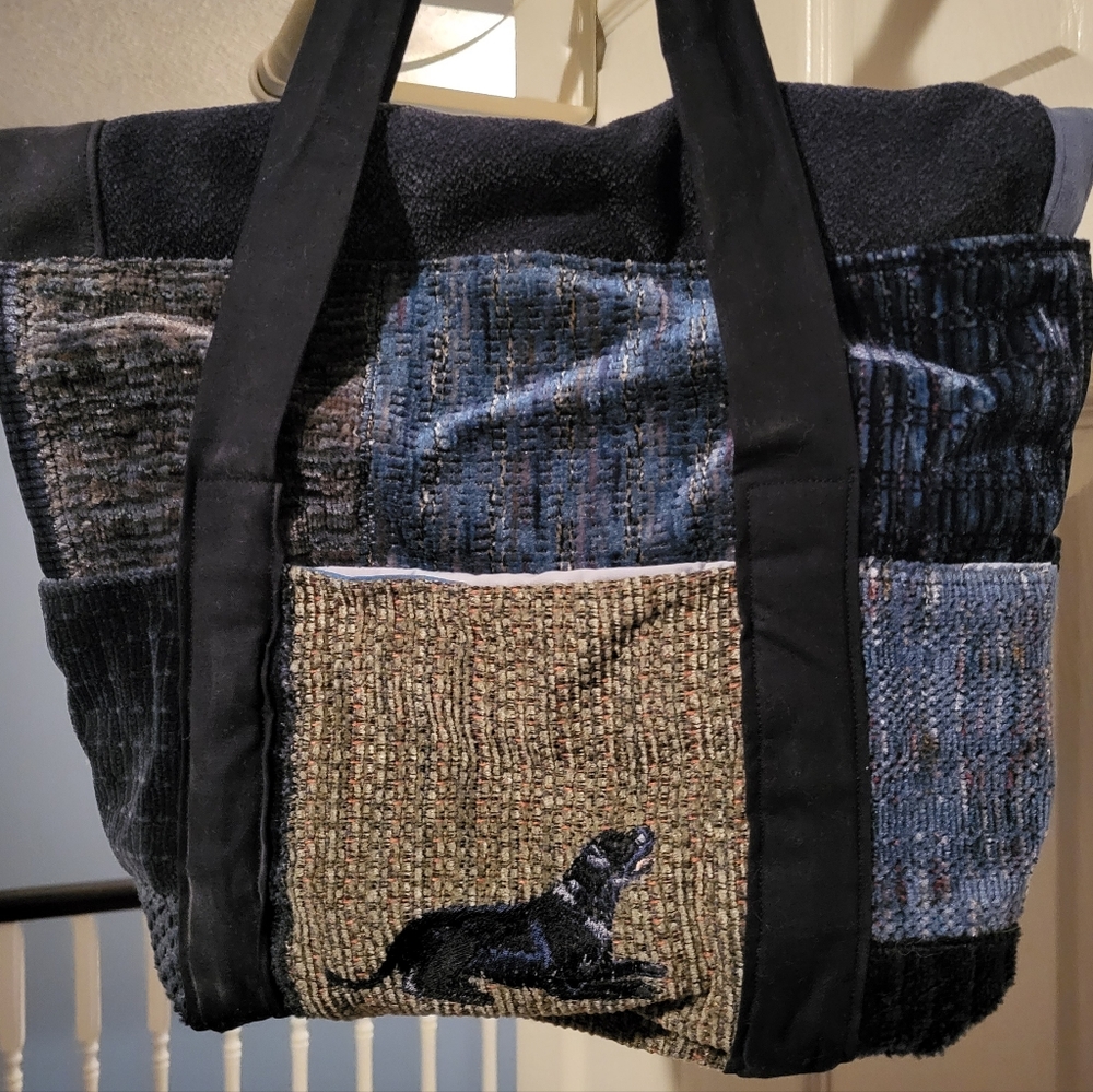 Hand held bag with black lab on pocket